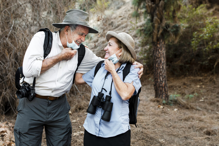 Happy senior couple travel during covid